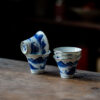 Collection of porcelain teacups with hand-painted blue and white designs from different angles.